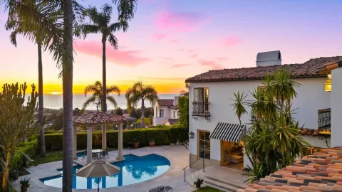 a view of a patio with a table and chairs