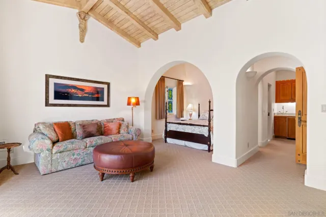 a living room with furniture and a ceiling fan