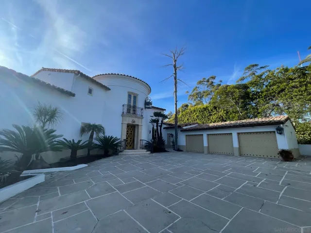 a dining room with furniture a chandelier and wooden floor