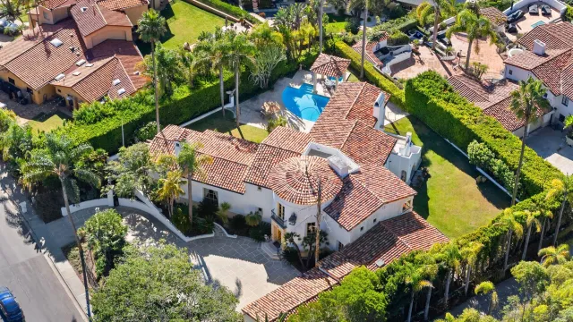 an aerial view of a house with a yard and garden