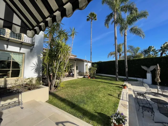 a view of a backyard with plants and a patio
