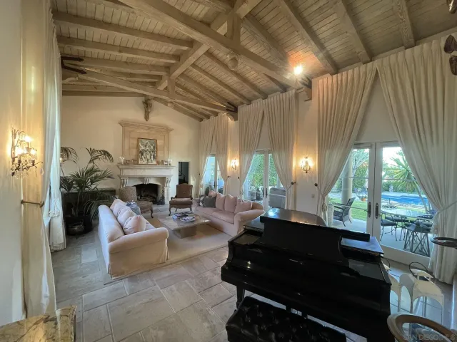 a living room with furniture fireplace and a large window