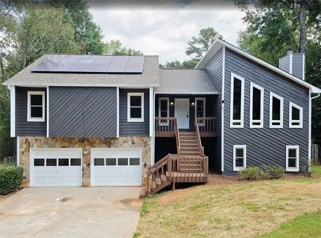 a view of a house with a yard and sitting area