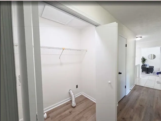 a view of a room with wooden floor