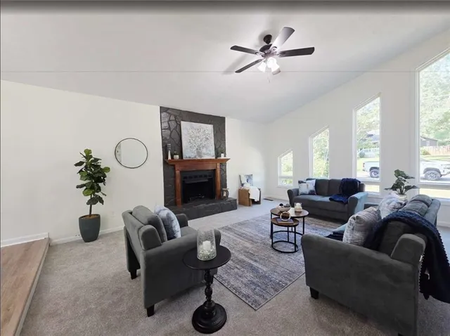 a living room with furniture a fireplace and a potted plant