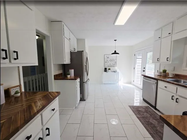 a kitchen with stainless steel appliances a refrigerator sink and stove