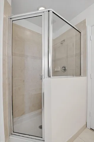 a bathroom with a glass shower door