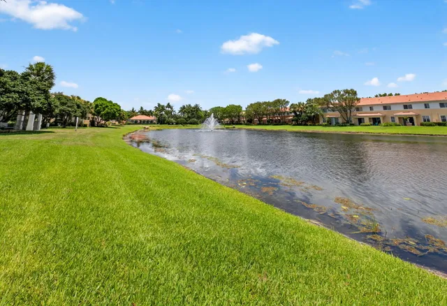 a view of a lake with houses in the back