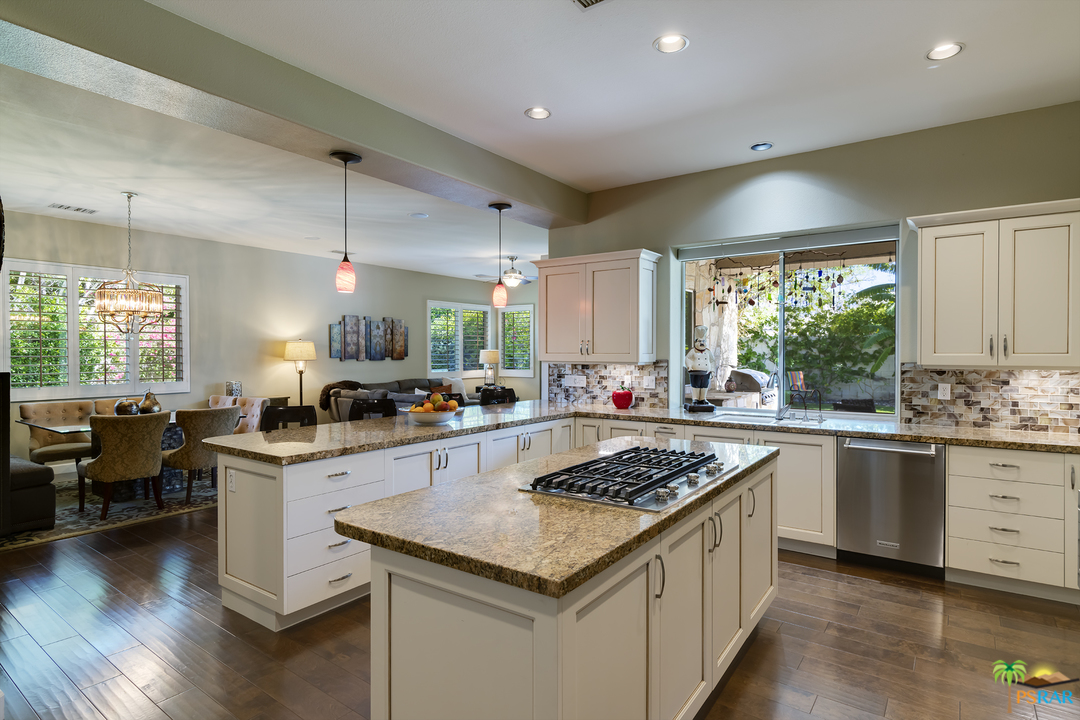 19 Sherwood Road Rancho Mirage, CA 92270 - Photo 8 of 18 a kitchen with a stove sink cabinets and wooden floor