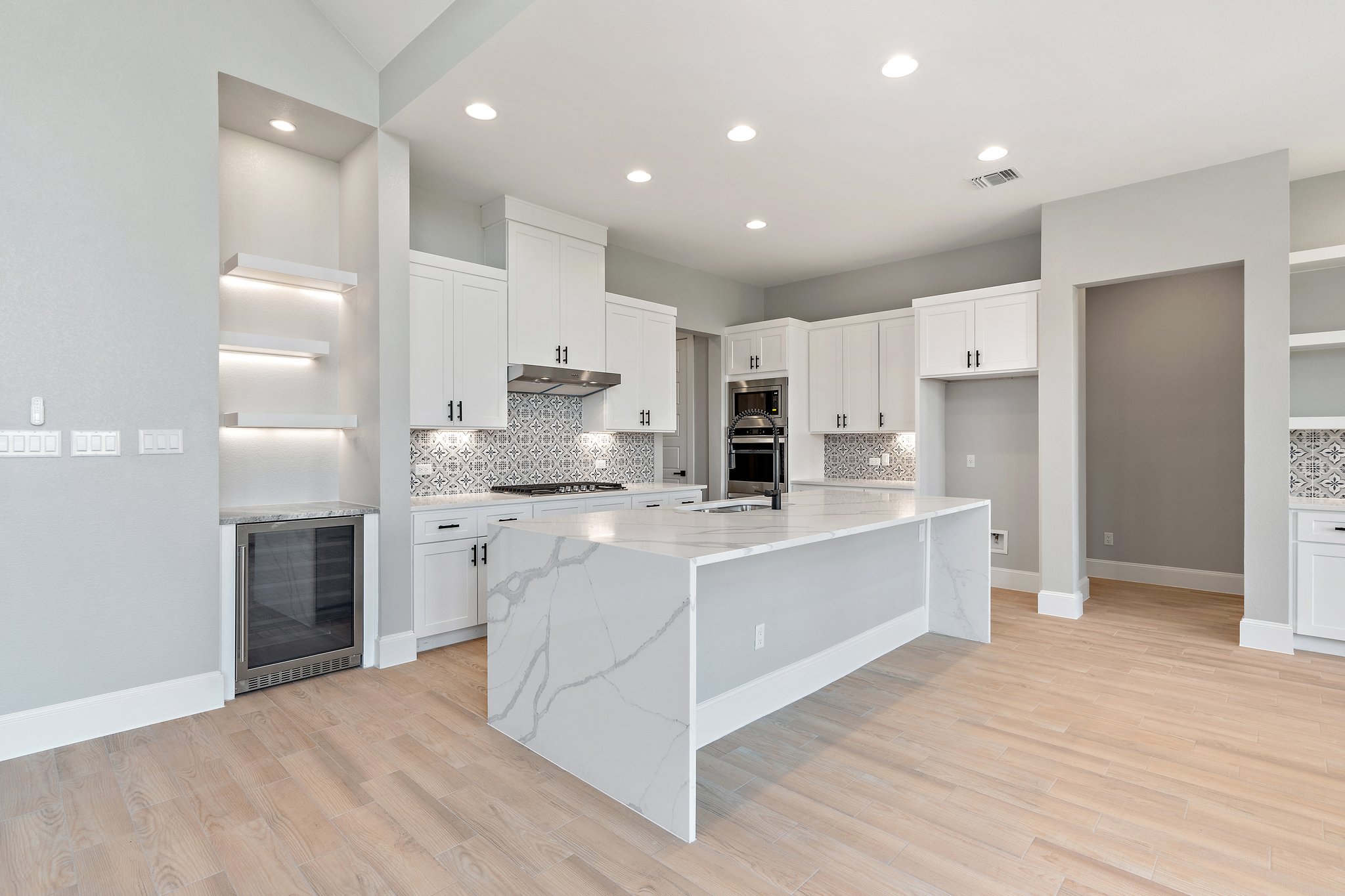 308 Axis Loop Georgetown, TX 78628 - Photo 14 of 40 a large kitchen with stainless steel appliances kitchen island granite countertop a refrigerator and a stove top oven