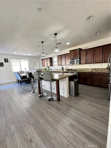 a view of kitchen with stainless steel appliances granite countertop lots of counter top space