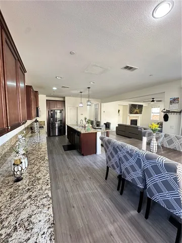 a living room with furniture and kitchen view
