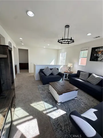 a living room with furniture a rug and a window