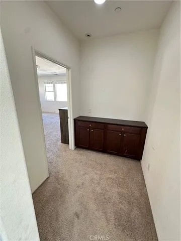a view of an empty room and hallway