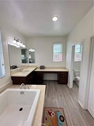 a bathroom with a tub sink and mirror
