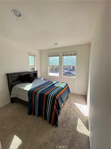 a bedroom with a bed and window