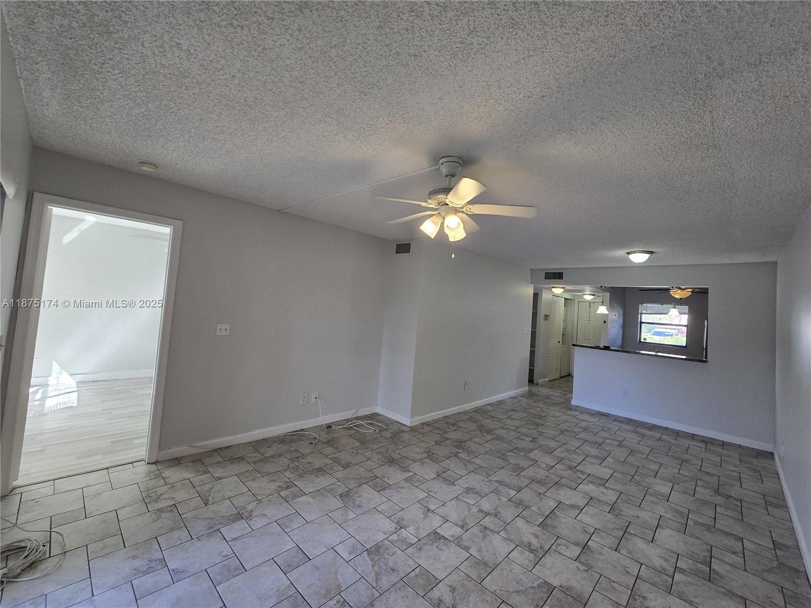 10600 Northwest 10th Street, Unit 106 Pembroke Pines, FL 33026 - Photo 4 of 17 a view of a livingroom with an empty space and a window