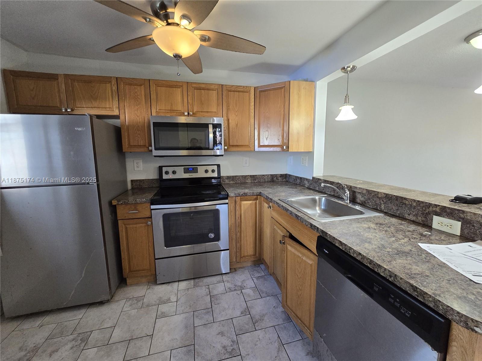 10600 Northwest 10th Street, Unit 106 Pembroke Pines, FL 33026 - Photo 6 of 17 a kitchen with a sink stove and refrigerator