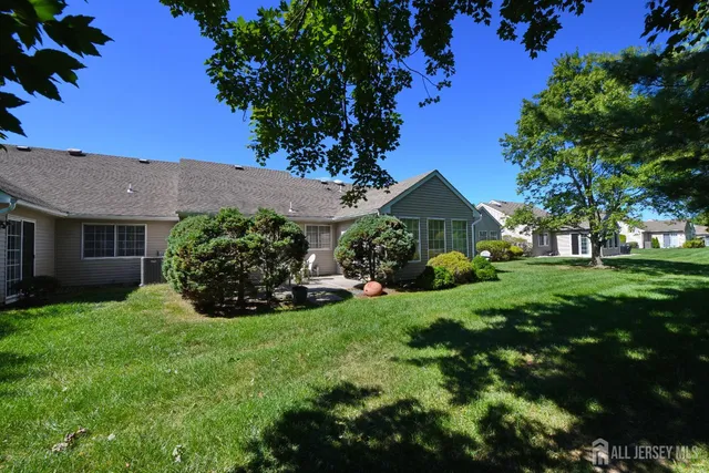 a view of sign board with yard and green space