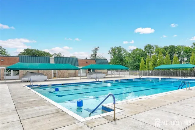 a view of a swimming pool with a yard