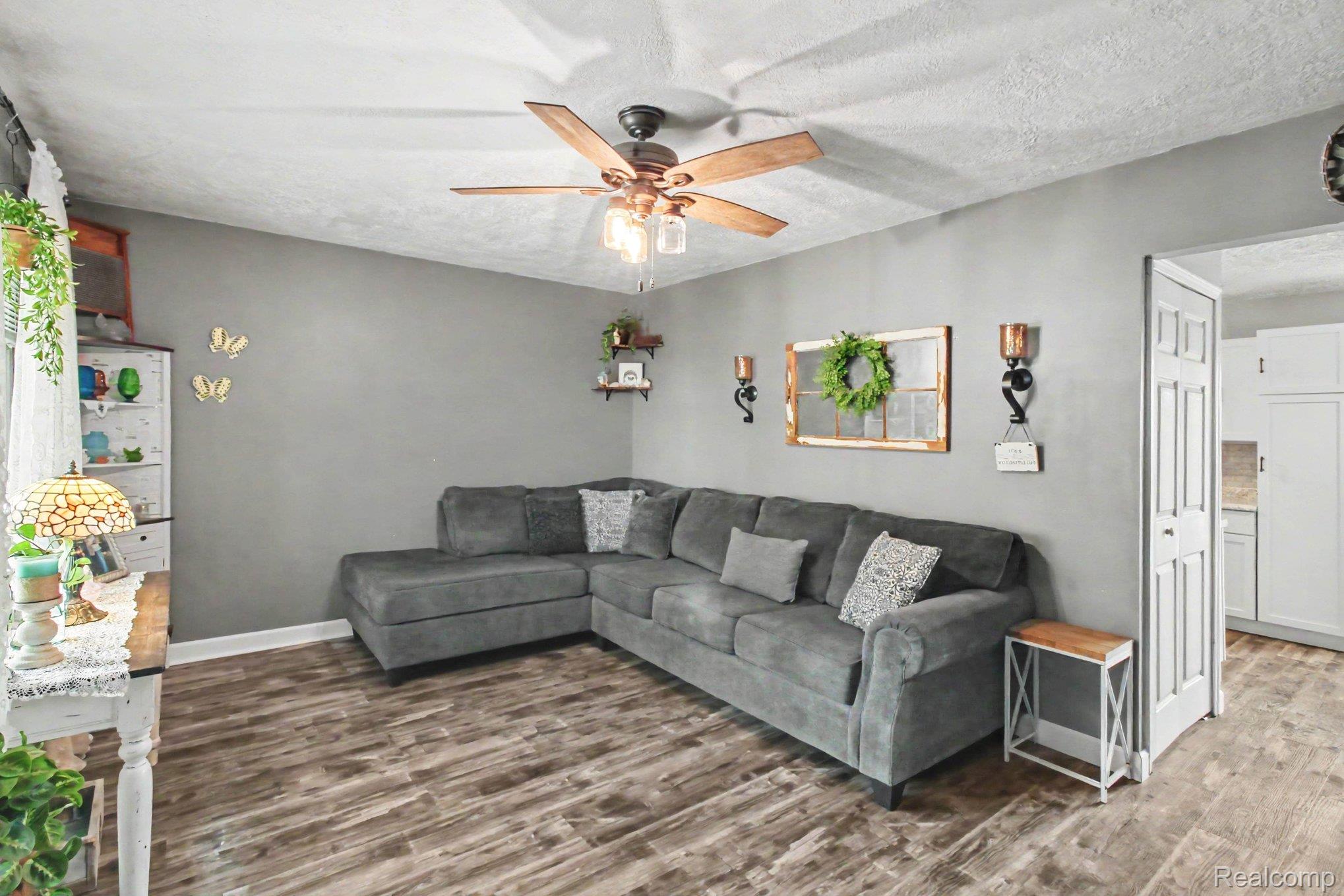 4623 West Lovejoy Road Byron, MI 48418 - Photo 4 of 21 Living room featuring a LVP finished floors and a ceiling fan
