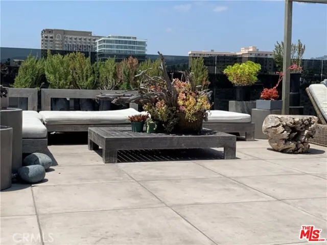 a view of a patio with couches and potted plants