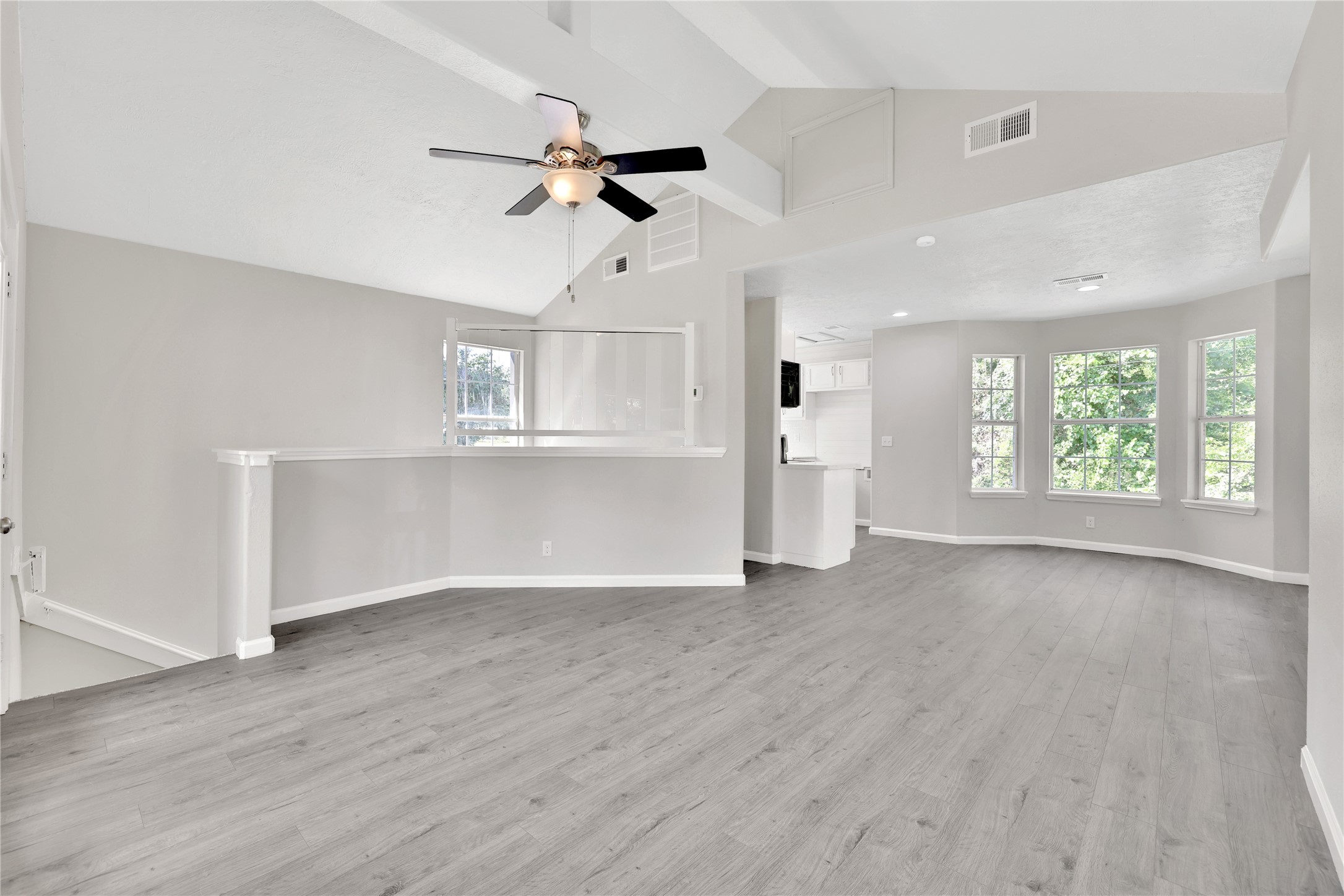 31 Montego Way Point Blank, TX 77364 - Photo 5 of 23 an empty room with wooden floor fan and windows