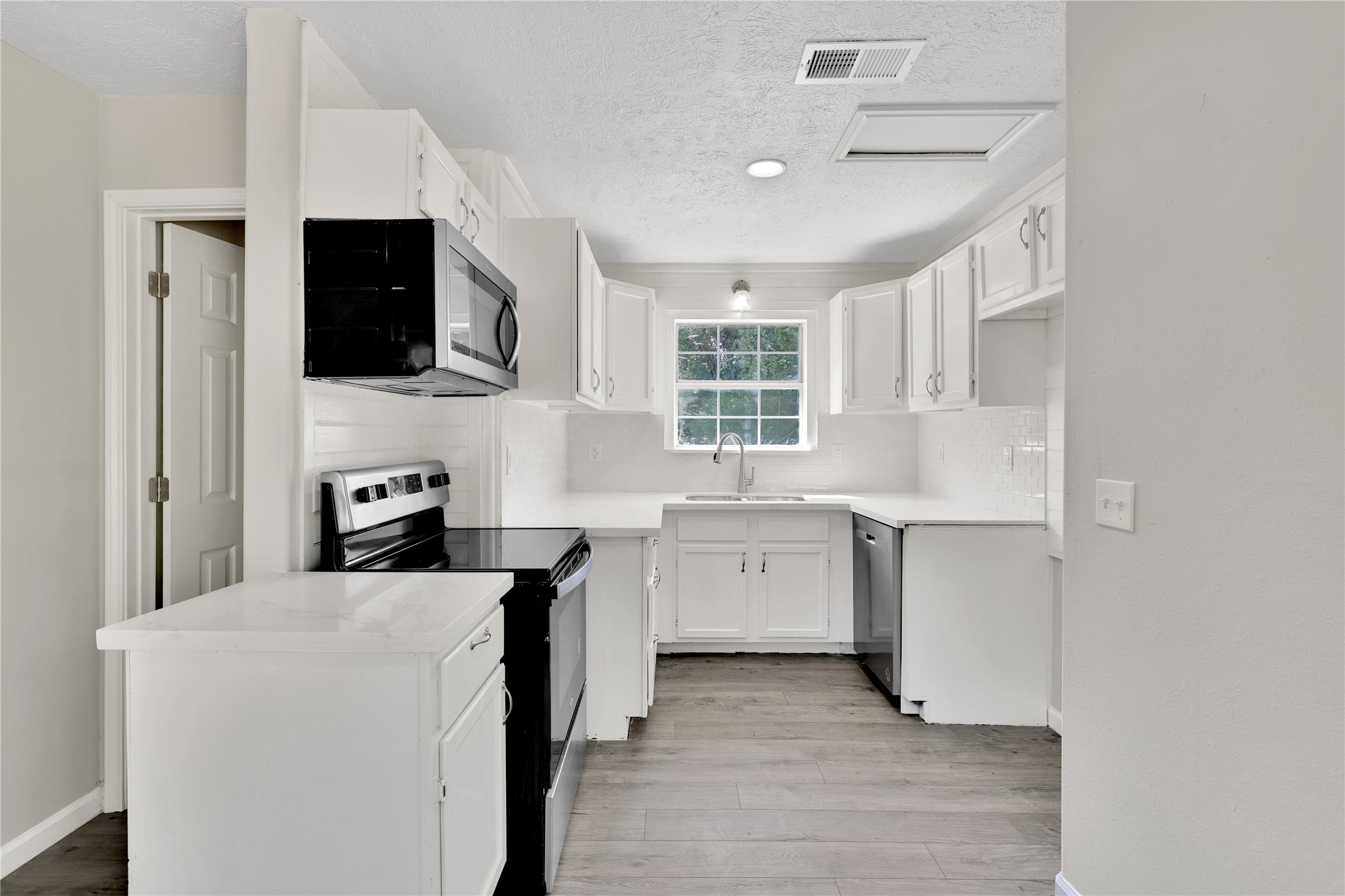 31 Montego Way Point Blank, TX 77364 - Photo 7 of 23 a kitchen with cabinets and window