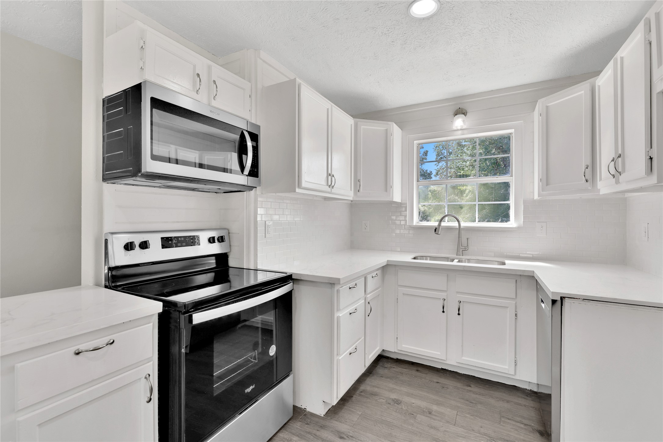 31 Montego Way Point Blank, TX 77364 - Photo 9 of 23 a kitchen with cabinets stainless steel appliances and a sink