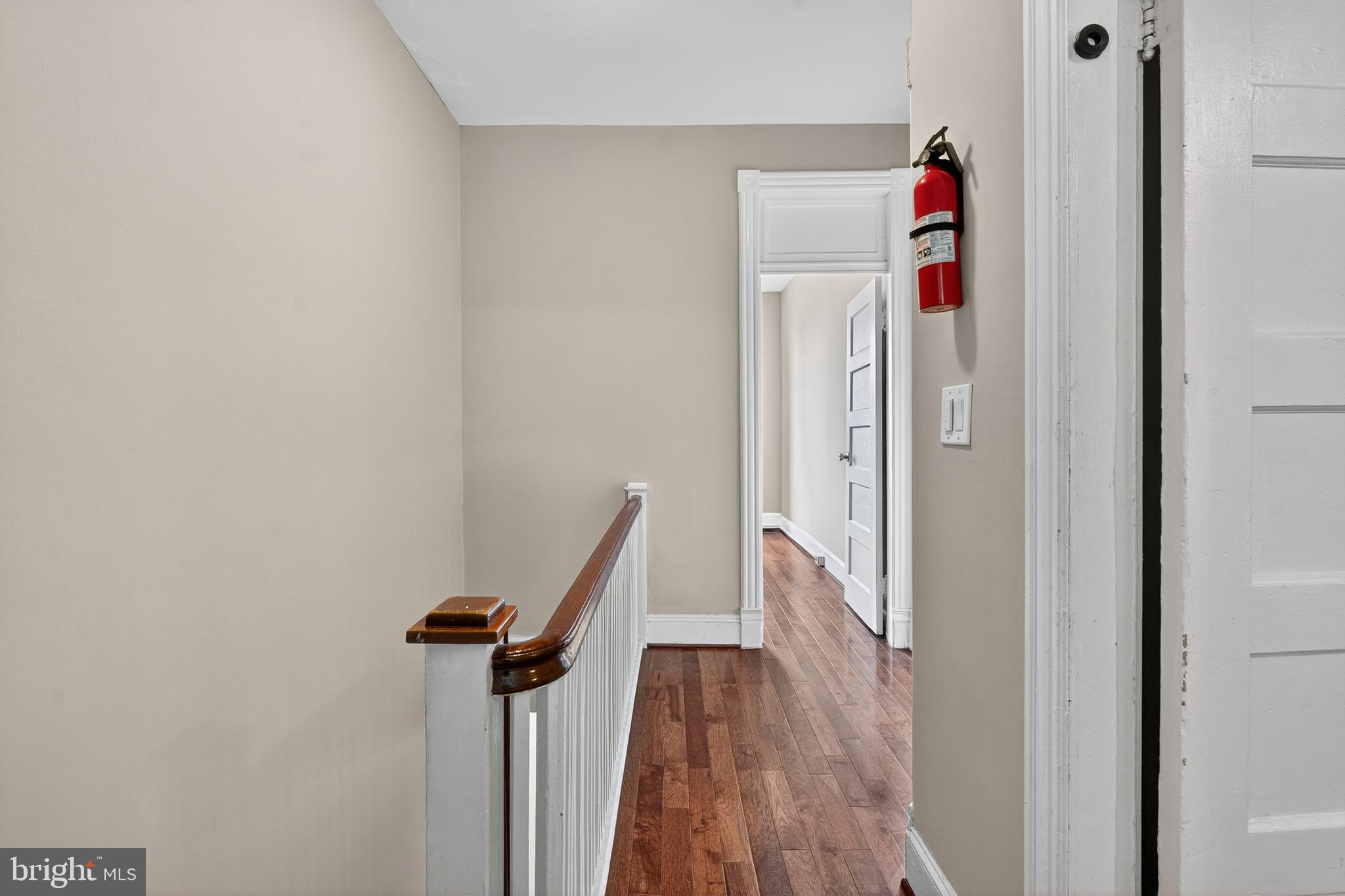3523 Warder Street Northwest Washington, DC 20010 - Photo 11 of 30 a view of a hallway with wooden floor and staircase