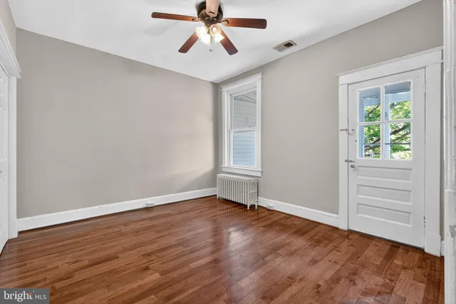 wooden floor in an empty room with a window