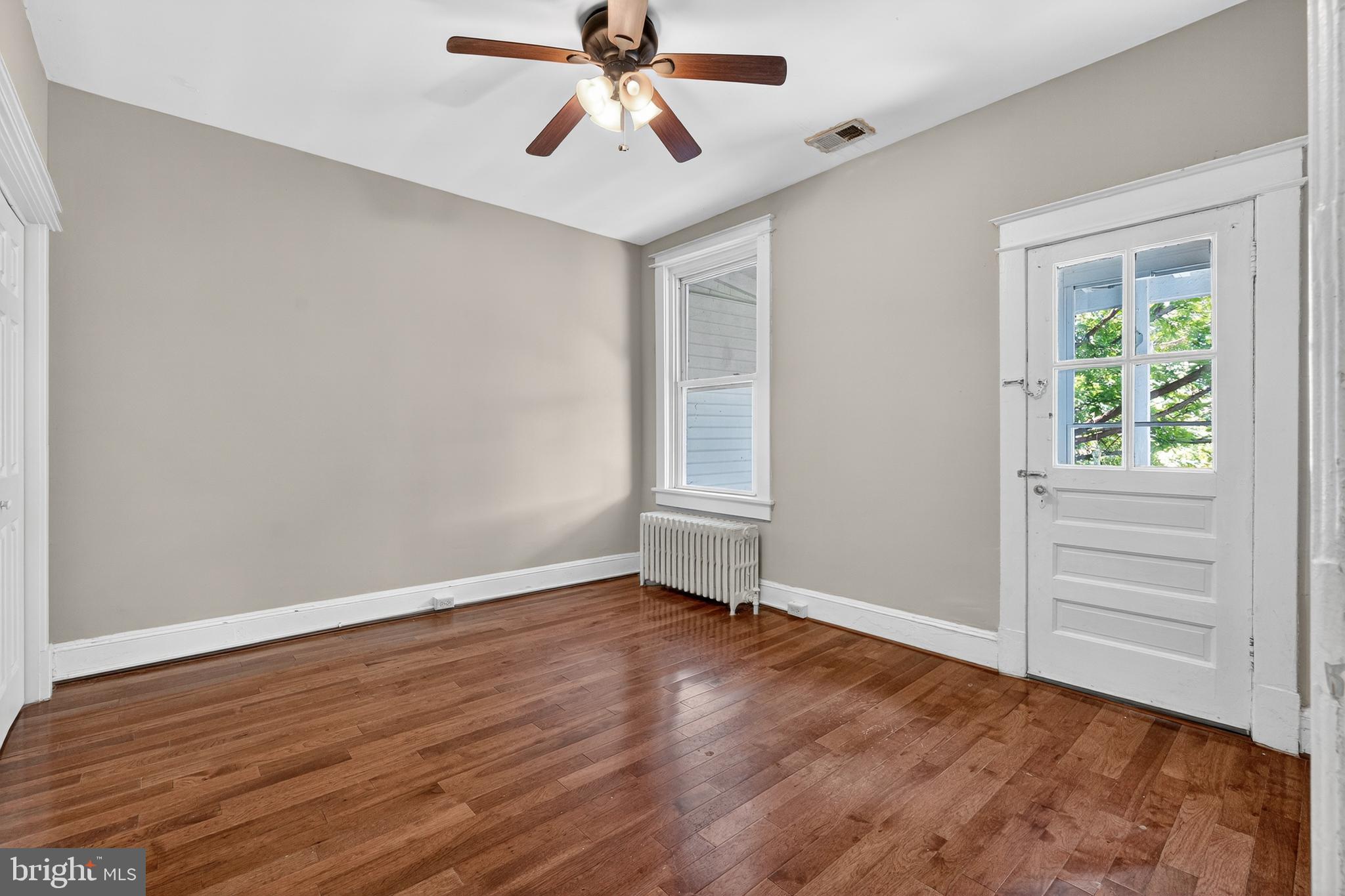 3523 Warder Street Northwest Washington, DC 20010 - Photo 12 of 30 wooden floor in an empty room with a window