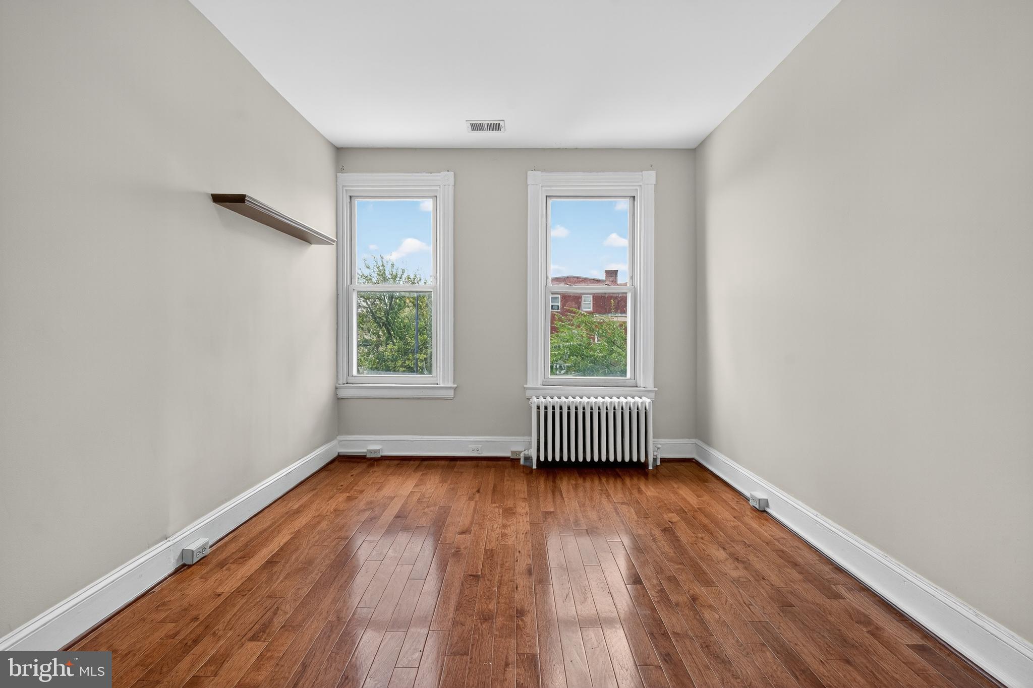 3523 Warder Street Northwest Washington, DC 20010 - Photo 15 of 30 an empty room with wooden floor and windows