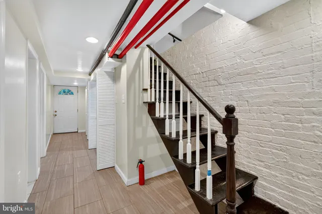 a view of entryway with wooden floor and stairs