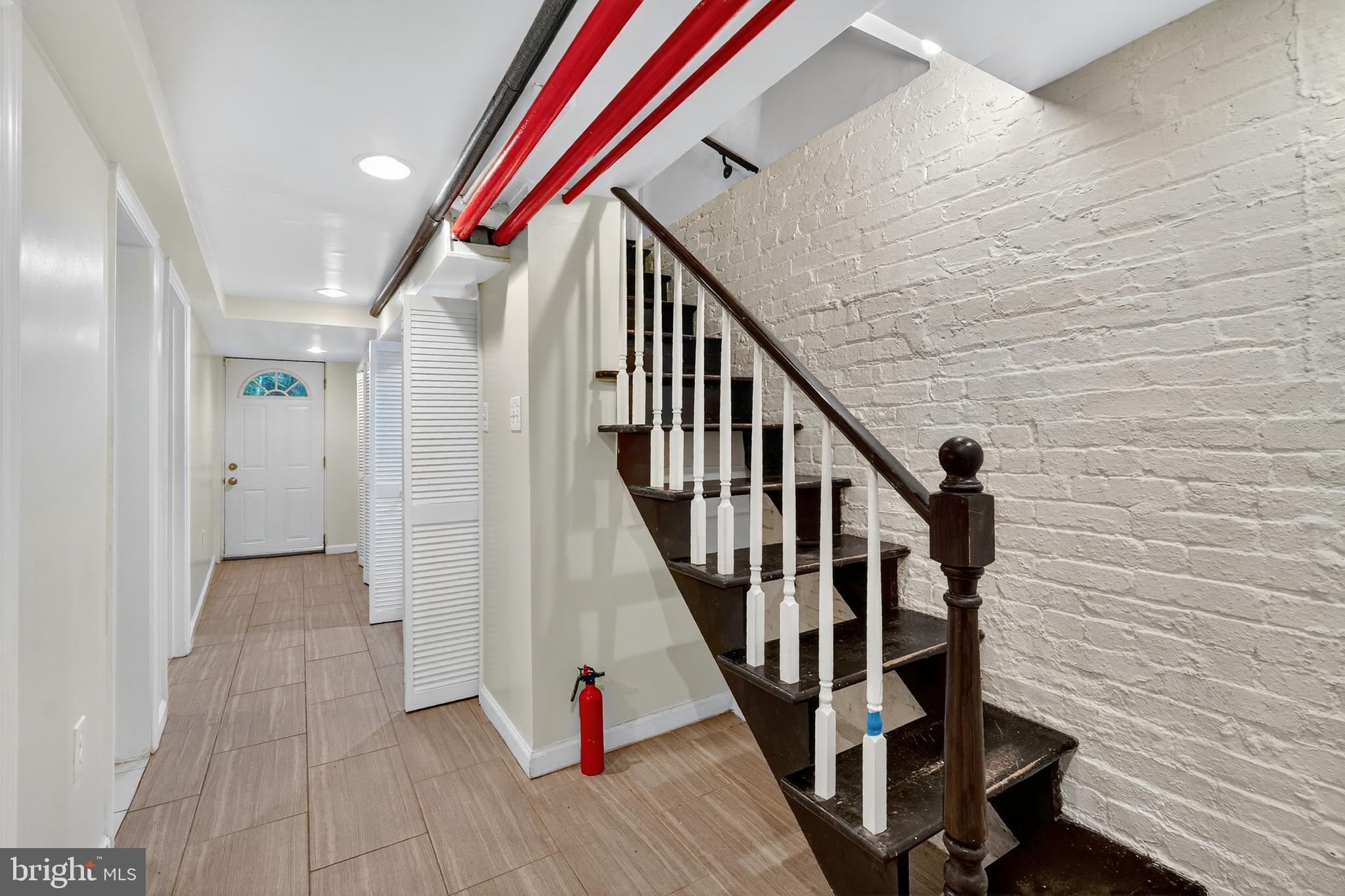 3523 Warder Street Northwest Washington, DC 20010 - Photo 20 of 30 a view of entryway with wooden floor and stairs