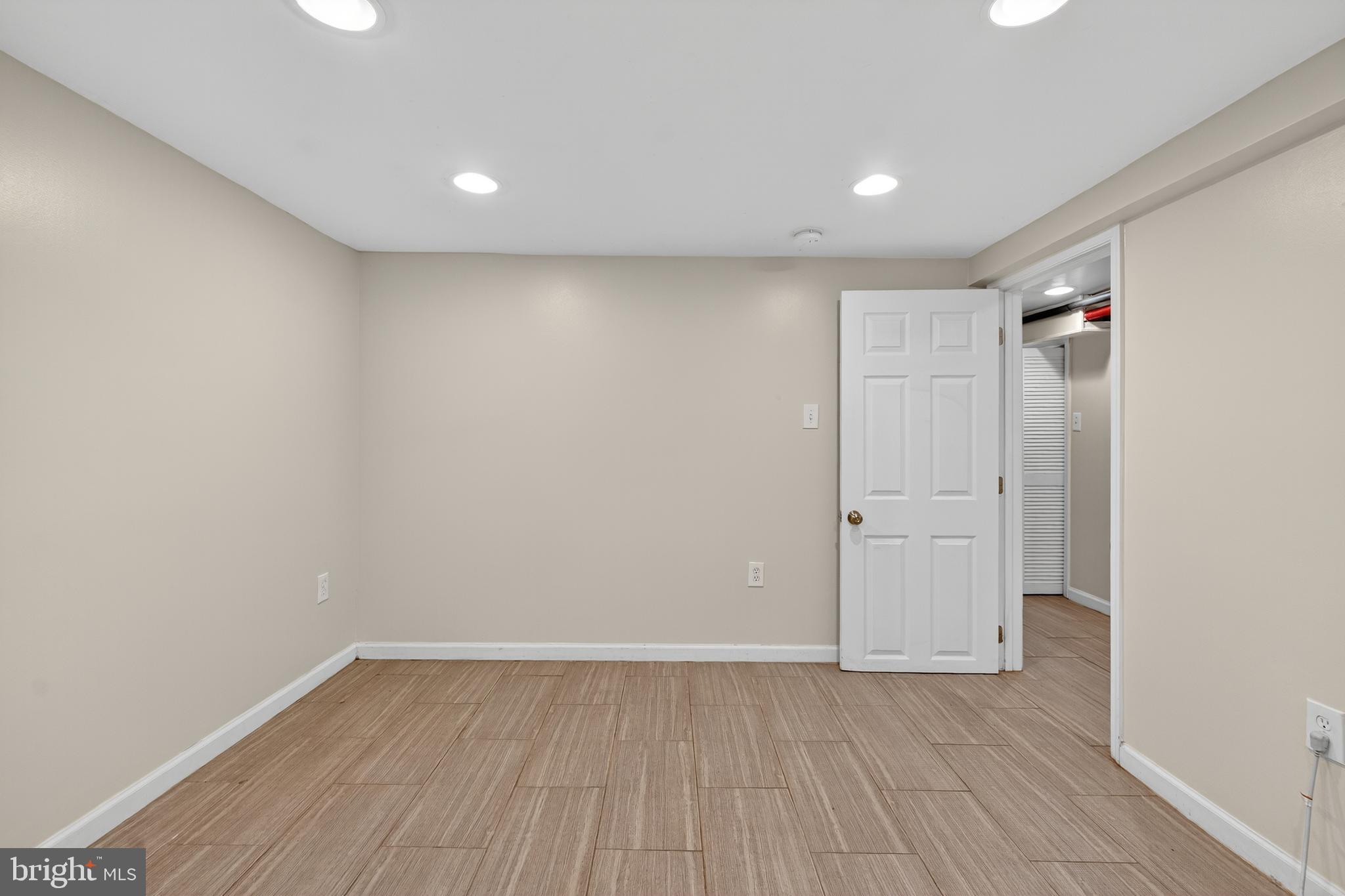 3523 Warder Street Northwest Washington, DC 20010 - Photo 21 of 30 a view of an empty room with wooden floor