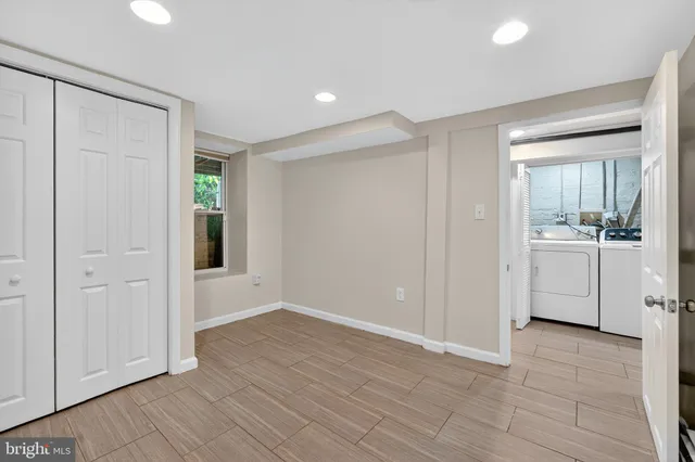 a view of a kitchen with white cabinets and sink