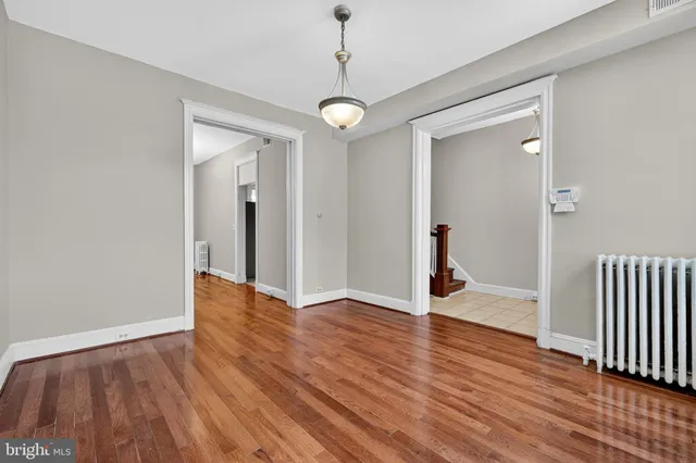 a view of a room with wooden floor