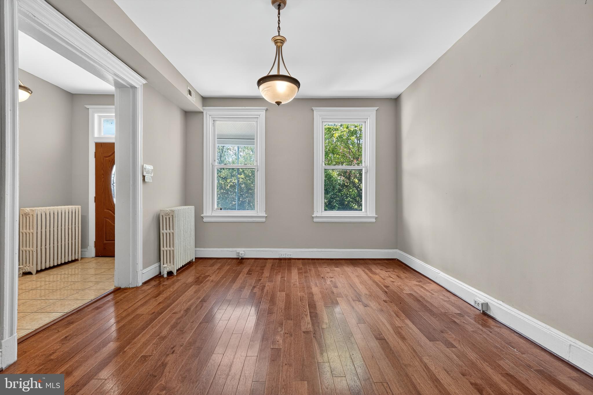 3523 Warder Street Northwest Washington, DC 20010 - Photo 5 of 30 a view of an empty room with wooden floor and a window