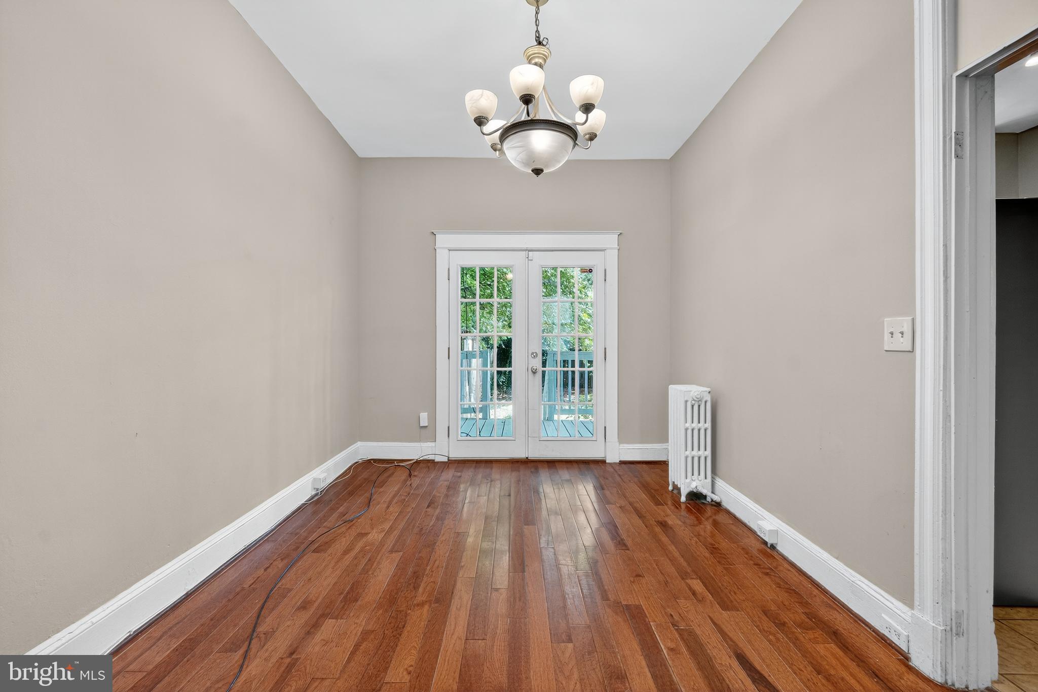 3523 Warder Street Northwest Washington, DC 20010 - Photo 9 of 30 a view of an empty room with wooden floor and a window