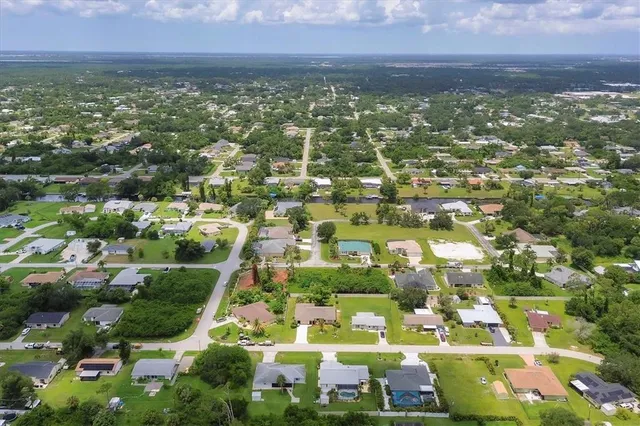 an aerial view of residential houses with outdoor space
