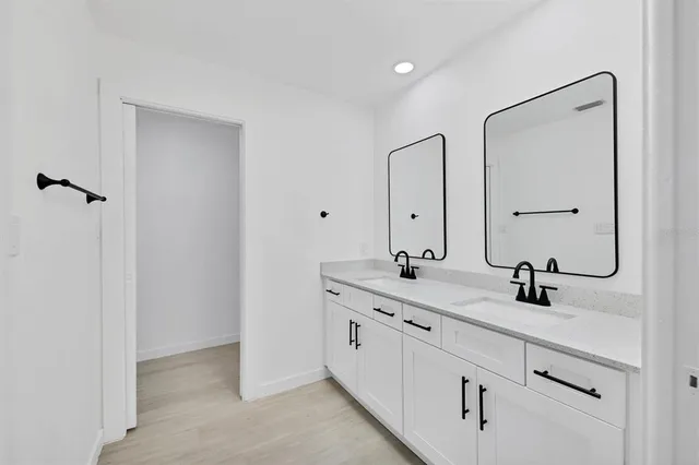a bathroom with a double vanity sink and mirror