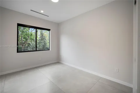 a bedroom with bed and a potted plant