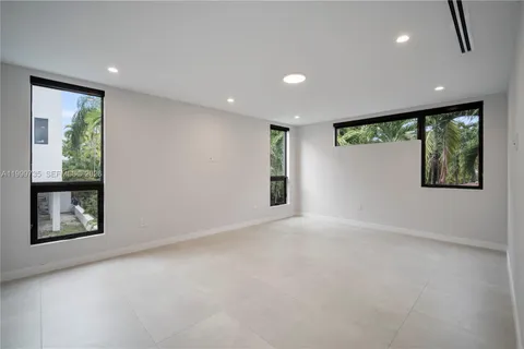 an empty room with windows and closet