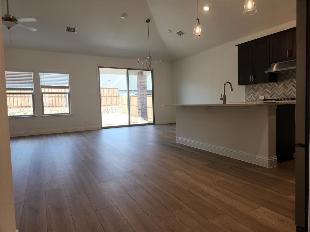 2433 Glacier Ridge Corinth, TX 76210 - Photo 11 of 40 wooden floor in kitchen and a window in a room