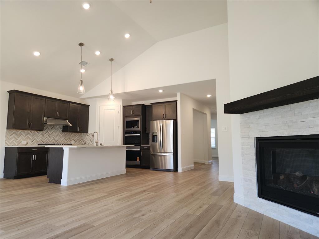 2433 Glacier Ridge Corinth, TX 76210 - Photo 12 of 40 a view of kitchen with a sink a microwave and cabinets