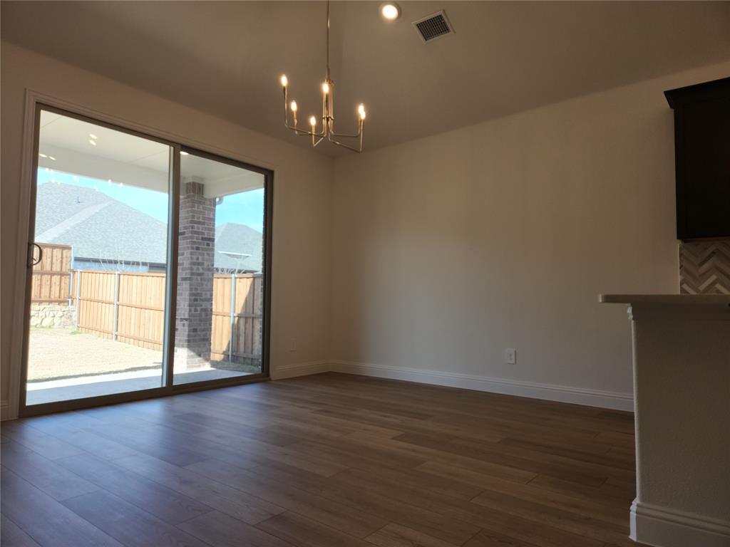 2433 Glacier Ridge Corinth, TX 76210 - Photo 17 of 40 an empty room with wooden floor and windows