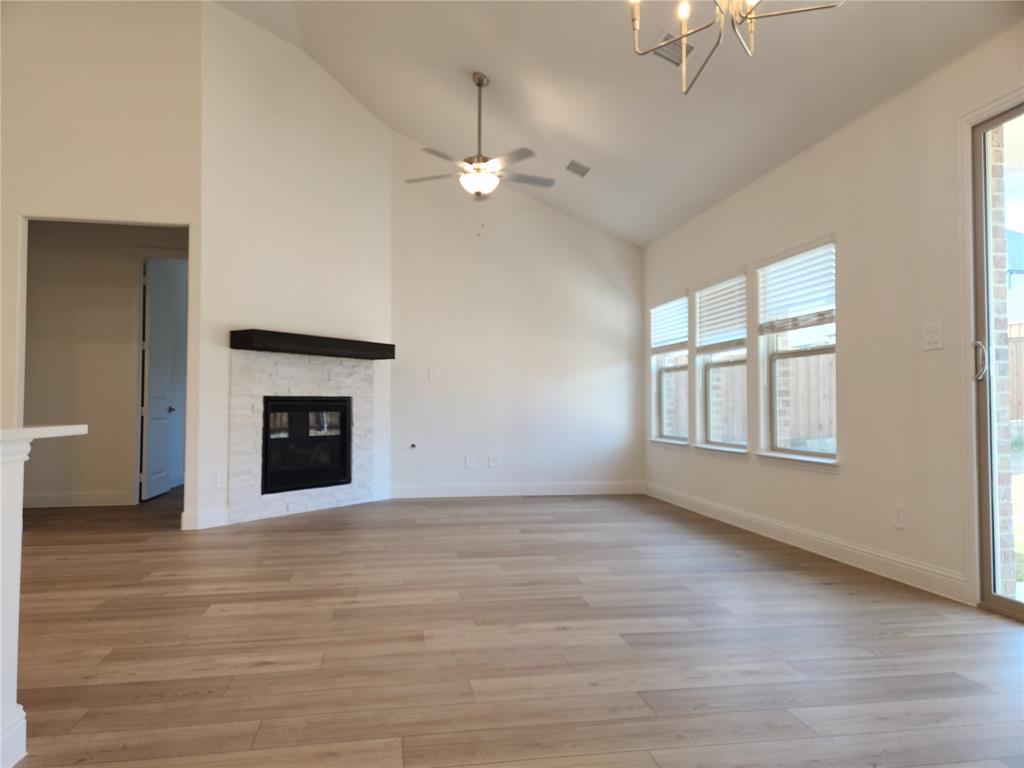 2433 Glacier Ridge Corinth, TX 76210 - Photo 18 of 40 an empty room with windows and a fireplace