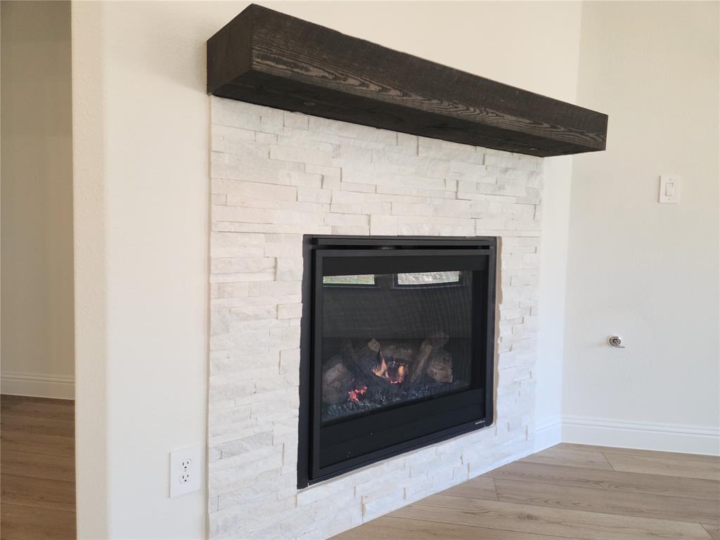2433 Glacier Ridge Corinth, TX 76210 - Photo 19 of 40 a living room with a fireplace