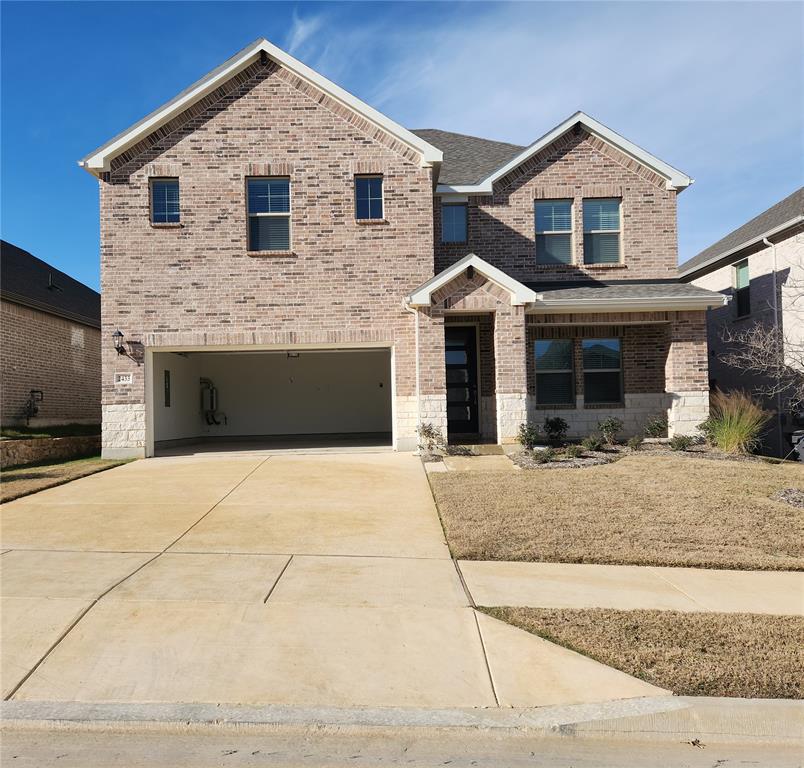 2433 Glacier Ridge Corinth, TX 76210 - Photo 2 of 40 a front view of a house with yard and garage